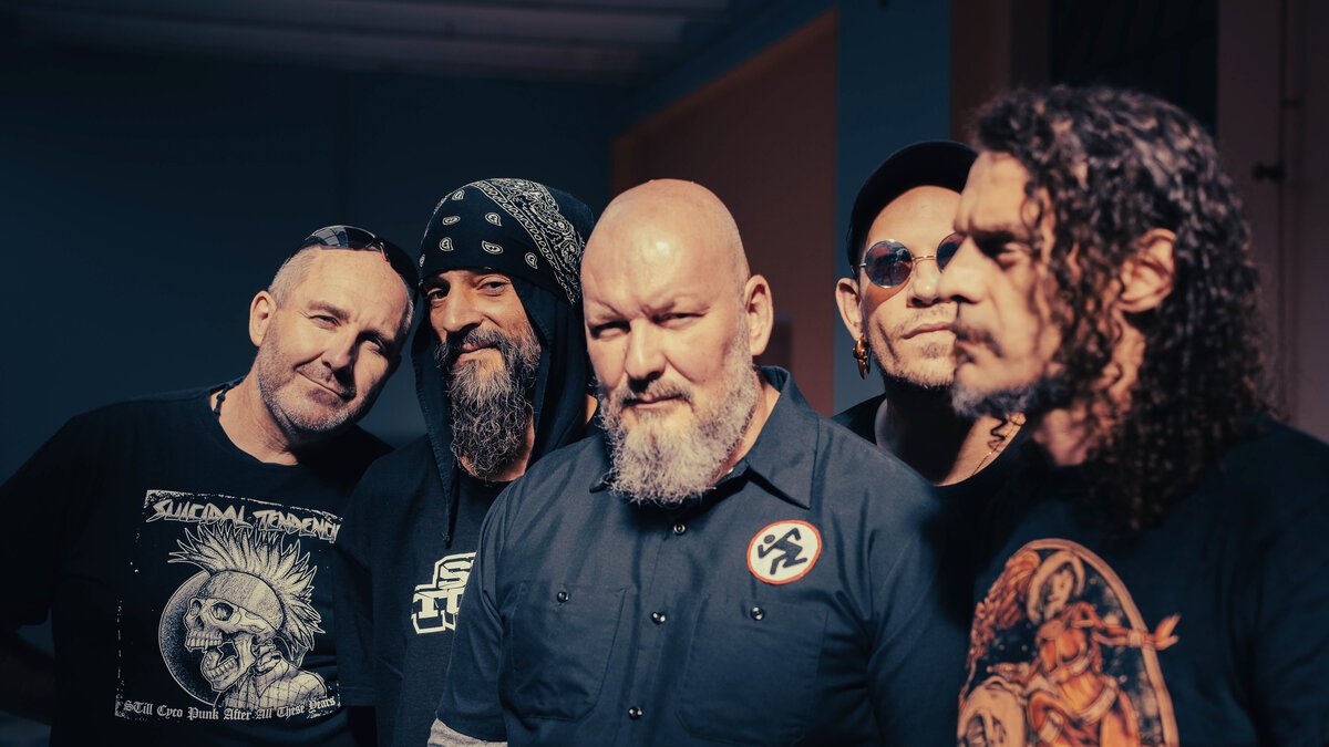 five-member metal/punk band group portrait, moody blue interior